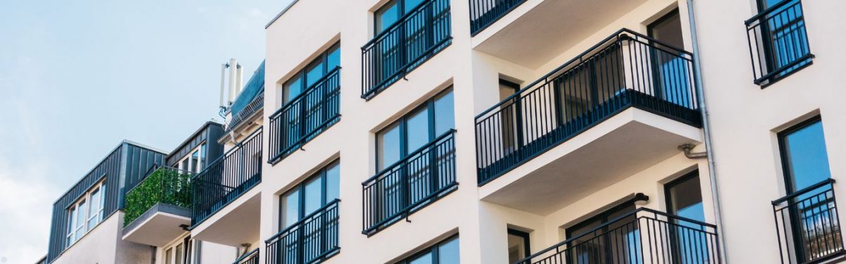 The exterior of an apartment building with balconies.